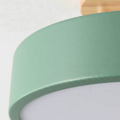 Close-up of a green lampshade with a wooden fixture on a white background