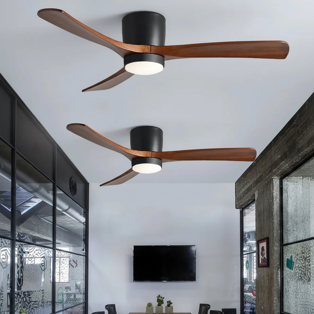 Two ceiling fans with wooden blades in a room with a TV and furniture.